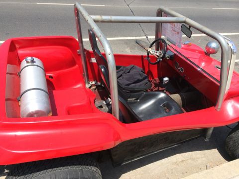 1968 Ford Mustang - This red dune buggy has a roll cage and exposed interior components.