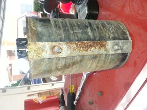1994 Ford Bronco - A rusted exhaust pipe section is shown, with a metal clamp secured by bolts.