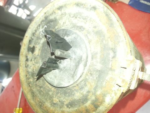 1994 Ford Bronco - This close-up shows a damaged engine component, possibly from a 1994 Ford Bronco, with pieces of black tape and a metal pin attached.