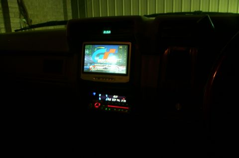 1981 Ford Bronco - Aftermarket screen and stereo installed in a car's dashboard. Digital clock shows 0:00.