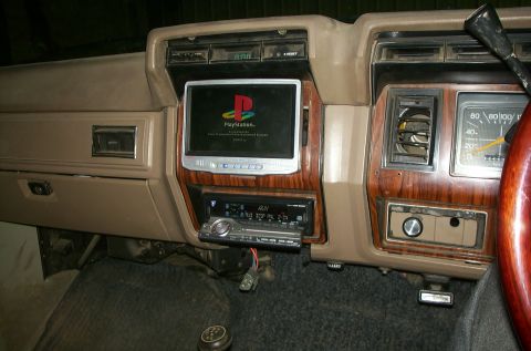 1981 Ford Bronco - The dashboard features an aftermarket screen and stereo system, along with the original speedometer.