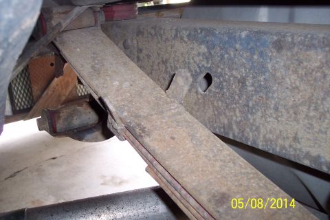 1978 Ford Bronco - Close-up view of the suspension system's leaf spring and frame components.