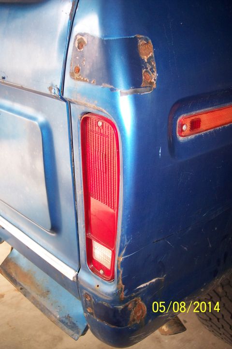 1978 Ford Bronco - Rear quarter panel detail of a blue 1978 Ford Bronco, showing rust and damage.
