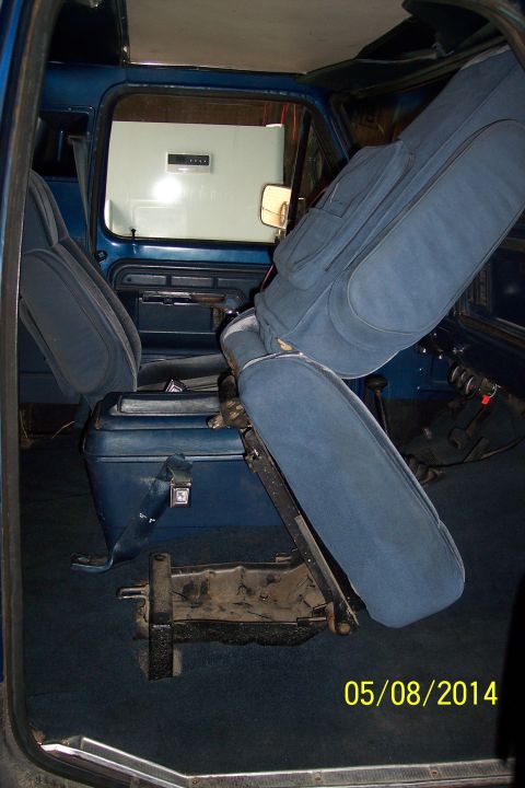 1978 Ford Bronco - Interior view of a 1978 Ford Bronco, showing the blue seats, dashboard, and center console.