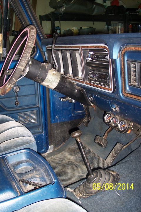 1978 Ford Bronco - Interior view of a 1978 Ford Bronco, the dashboard, steering wheel, and floor shifter.