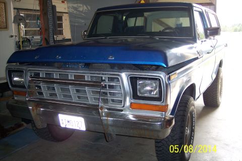1978 Ford Bronco - This 1978 Ford Bronco is parked inside a garage with its hood up, showing the front grille and headlights.
