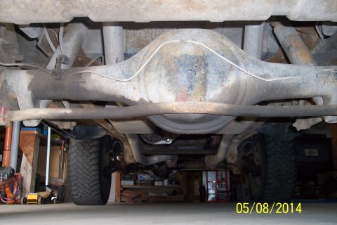1978 Ford Bronco - Undercarriage view of a vehicle, focusing on the rear axle and suspension system.