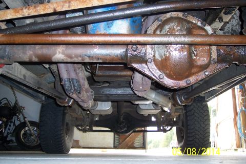 1978 Ford Bronco - Undercarriage view of a vehicle, revealing the differential, exhaust system, and tires. No year-specific details are visible.