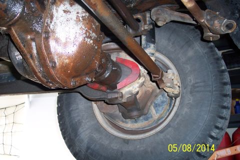1978 Ford Bronco - Close-up of the undercarriage shows the vehicle's rear axle assembly and suspension parts.