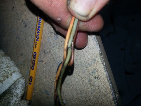 1994 Ford Bronco - Close-up of wires with a pencil for scale, no vehicle is visible.