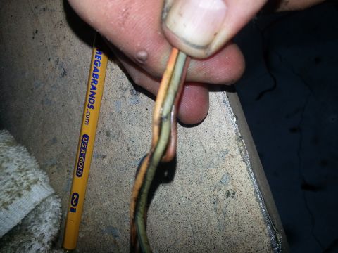 1994 Ford Bronco - Frayed battery cables are shown next to a pencil with visible text and branding.