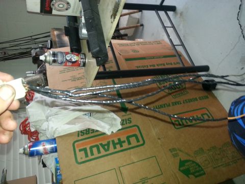1994 Ford Bronco - Wiring harness connector and associated wires are visible, along with spray cans and storage boxes.