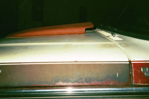 1979 Ford Bronco - A red hood scoop is mounted on the roof of a 1979 Ford Bronco.
