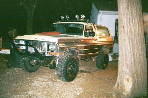 1979 Ford Bronco - Modified 1979 Ford Bronco parked outdoors at night, off-road tires and lighting.
