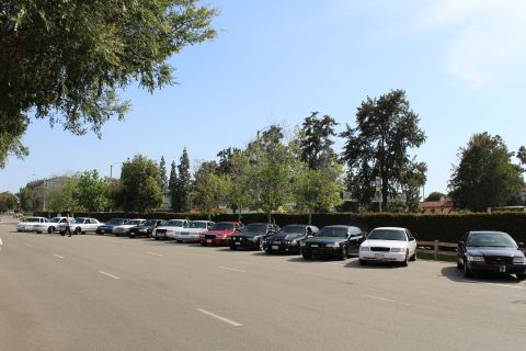 Sedans parked diagonally along a wide empty lot