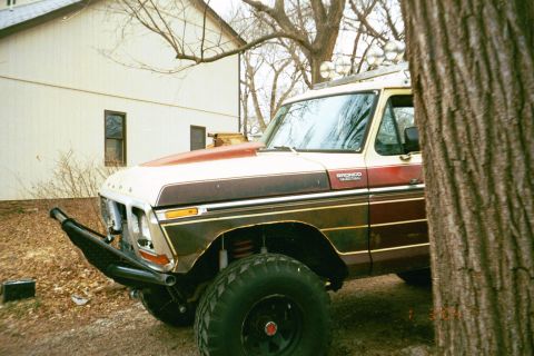 1979 Ford Bronco - 1979 Ford Bronco in front of a house, modified with a heavy-duty bumper and off-road tires.