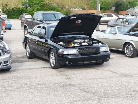2003 Mercury Marauder - A black 2003 Mercury Marauder is parked with its hood open, showing the engine bay.