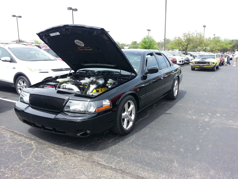 Black sedan with hood open, engine exposed. Supermotors.net logo visible