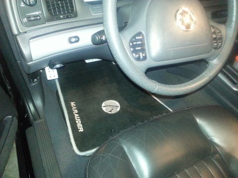 2003 Mercury Marauder - Custom floor mats for a 2003 Mercury Marauder are visible in the driver's side footwell.
