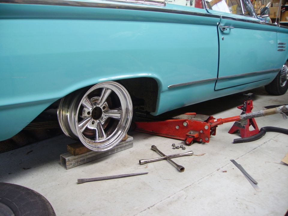 Turquoise 1964 Mercury Monterey convertible side view, wheel removed for service