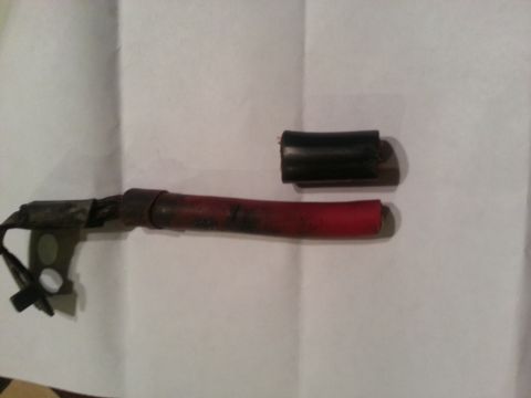 1994 Ford Bronco - Close-up of automotive battery cables, one red and one black, with a separate black sleeve.