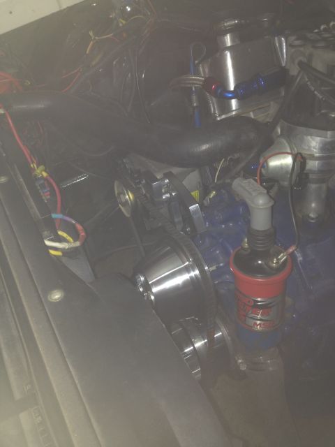 1972 Ford Ranchero - Close-up of an engine bay, focusing on the ignition coil and associated wiring and pulleys.