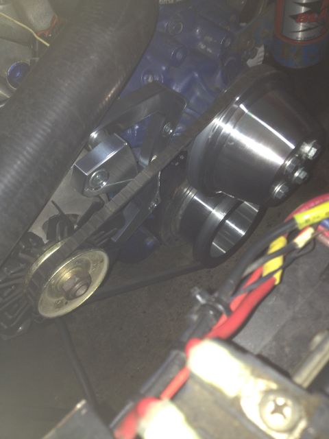 1972 Ford Ranchero - A close-up view of a vehicle's engine, focusing on the water pump assembly and drive belt.