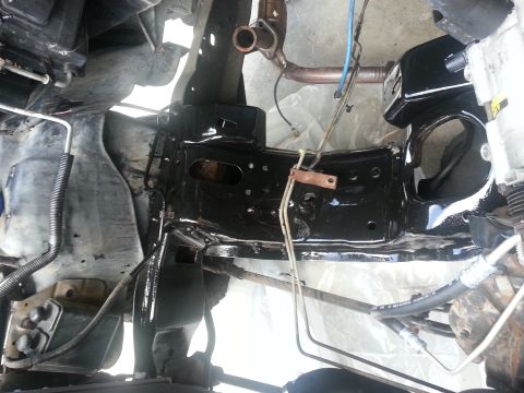 1994 Ford Bronco - Close-up view of a vehicle's engine bay, showing the frame and various mechanical components.