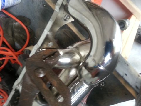 1994 Ford Bronco - A close-up view of a shiny exhaust pipe with a pair of old pliers resting on it.