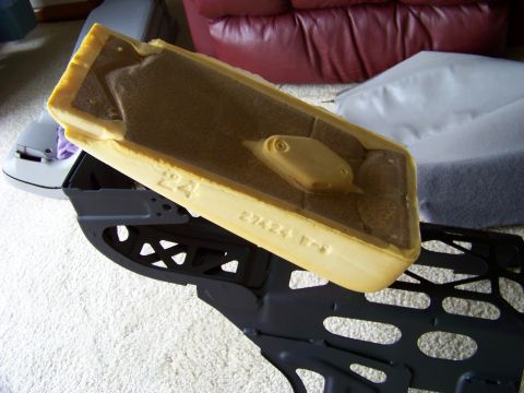 1999 Mercury Grand Marquis - Close-up of a car seat's foam padding and its underlying metal frame, showing stamped part numbers.