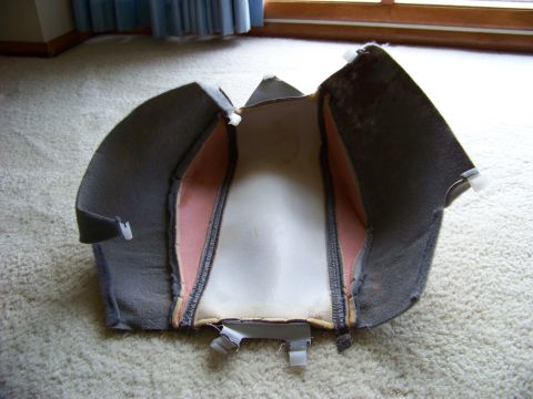 1999 Mercury Grand Marquis - A disassembled car seat cushion is shown on a carpeted surface, revealing its internal padding and fabric layers.