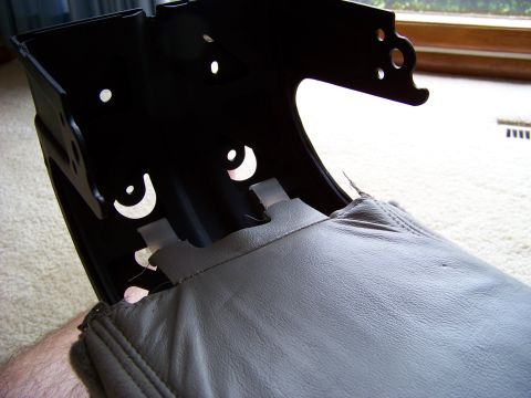 1999 Mercury Grand Marquis - Detail of a car seat interior part, showing gray leather upholstery and black metal structure.