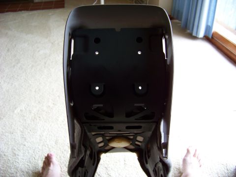 1999 Mercury Grand Marquis - Underside view of a car seat base, showing mounting points and structural supports.