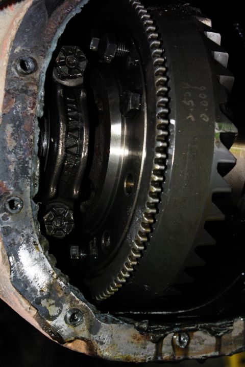 1995 Ford Bronco - Close-up of a differential gear assembly, showing internal components and a toothed ring. Some markings are visible on the gear.