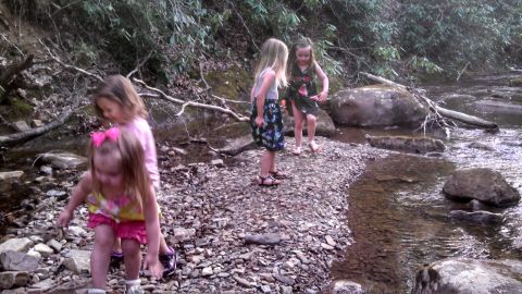 1979 Ford Bronco - Children explore the shallow waters of a stream on a rocky bank.