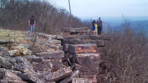 1979 Ford Bronco - Hikers enjoy the view from a high vantage point on a rocky outcrop.