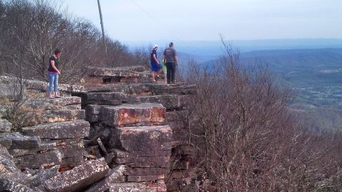 1979 Ford Bronco - People enjoy a scenic view from a high vantage point on a rocky outcrop.