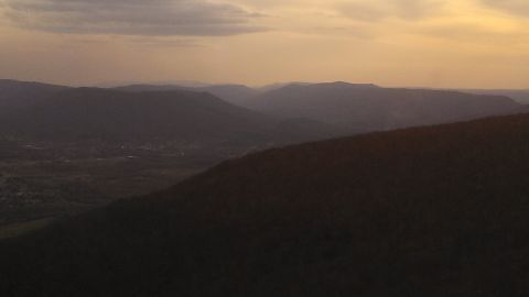 1979 Ford Bronco - Sunset over a mountain range and valley, with the Supermotors logo visible.