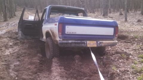 1979 Ford Bronco - This 1979 Ford Bronco is stuck in the mud with its driver's door open.