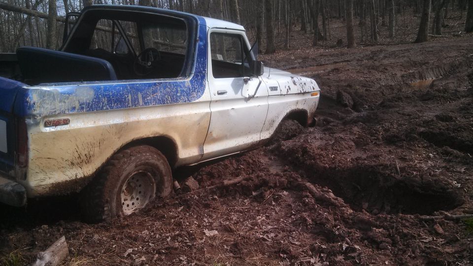1979 Ford Bronco stuck in mud, 3/4 front view
