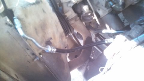 1979 Ford Bronco - A close-up view of a power steering hose, likely from an older vehicle.
