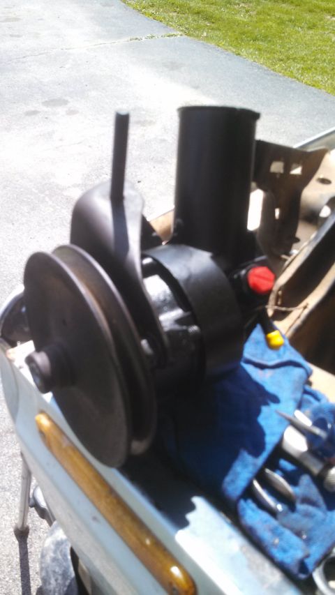 1979 Ford Bronco - Close-up of a power steering pump, likely removed from a vehicle for repair or replacement.