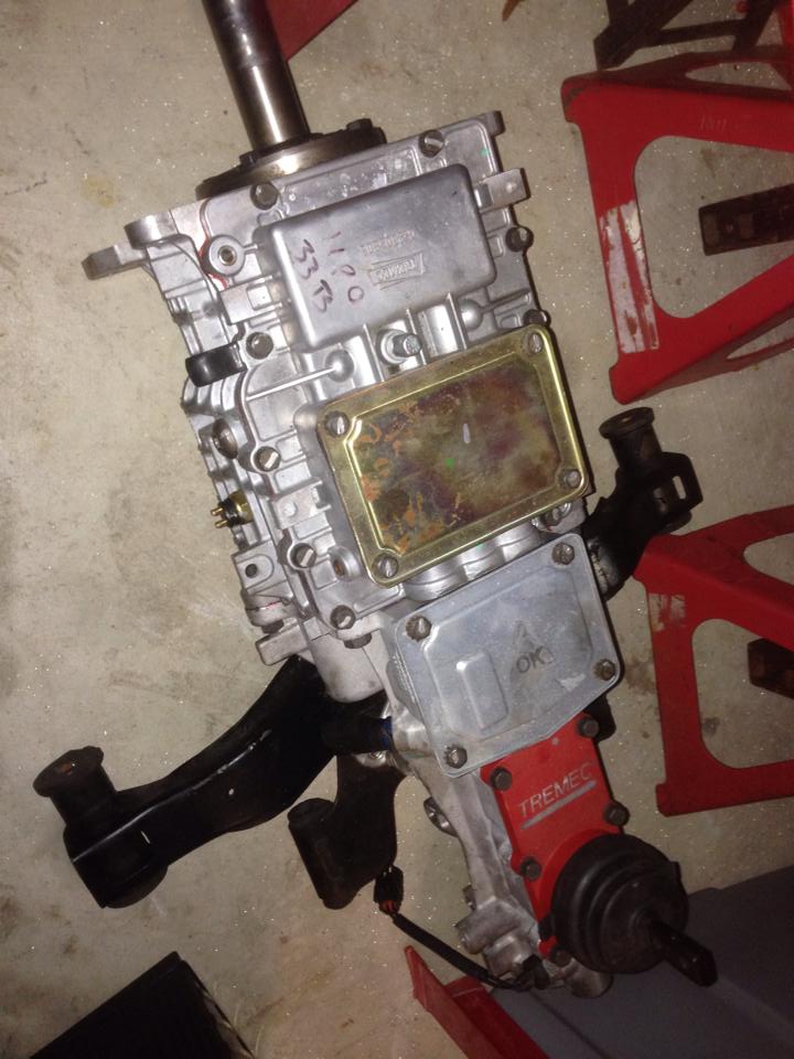Close-up of a Tremec transmission with some handwritten numbers and a gold plate