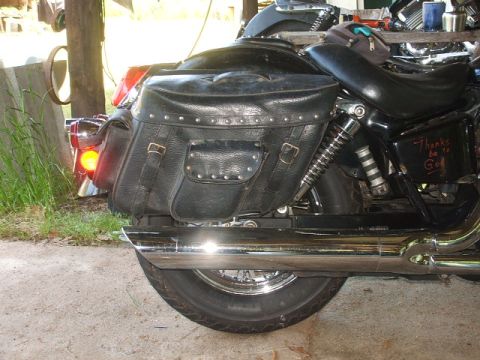 1998 Honda Shadow VT750C - A motorcycle's rear section with black leather saddlebags and chrome exhaust pipes is visible.