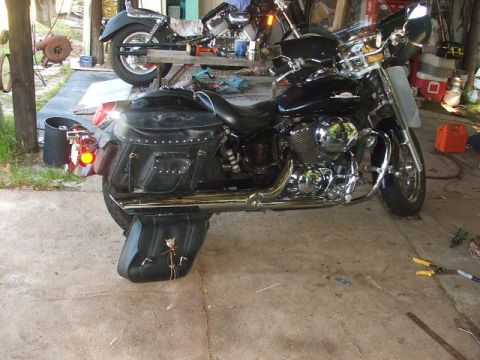 1998 Honda Shadow VT750C - A motorcycle is parked inside a garage, with tools and another motorcycle visible.