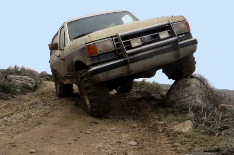 1989 Ford Bronco - 1989 Ford Bronco navigating difficult terrain off-road.