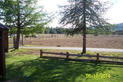 1973 Ford F-250 - A truck is visible in a wide shot of a rural landscape, a field, trees, and fences.