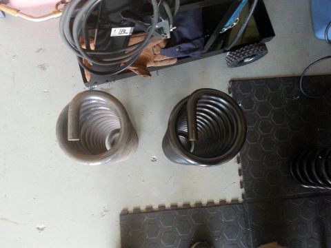 1992 Ford Bronco - Two coil springs are shown, one appears to be new and the other used.