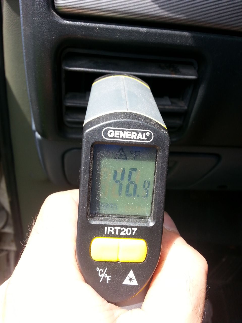 General IRT207 thermometer reading 46.9F pointed at a vehicle air vent