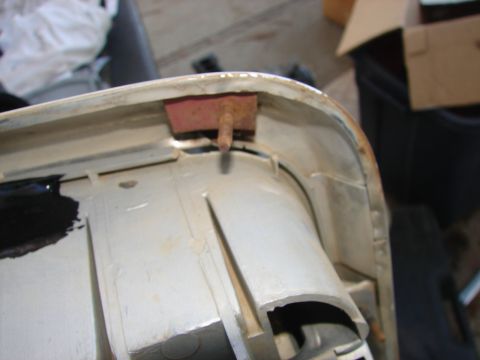 1973 Ford Ranchero - Detail of a vehicle fender assembly showing a rusty pin and rubber bumper, likely for mounting or cushioning.